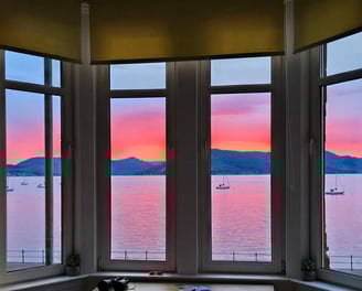 View from the window at at Gourock Seaview Holiday Let with a view of the ocean and sunset