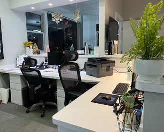 The desks to the receptionists inside a small office.