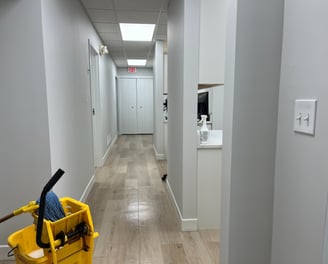 a yellow bucket with a mop on the freshly mopped floor