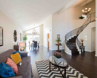 large living/dining area with elegant spiral staircase