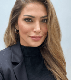 a woman with long hair and a black jacket