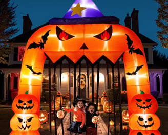 a couple of kids standing in front of a halloween themed archway