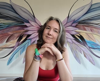 a yoga teacher with a large wings in background