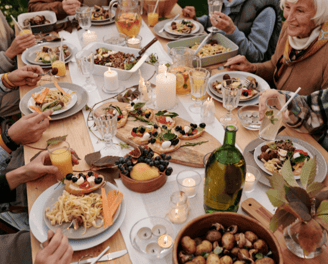 A group dinner with the image focused mostly on the plates of food