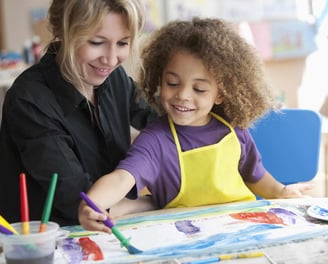 a woman and a child are smiling and having fun
