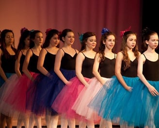 a group of young girls in colorful tulle skirts and tututututu