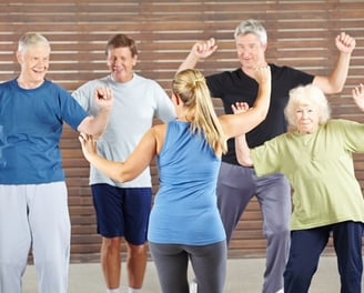 a group of older people doing a dance routine