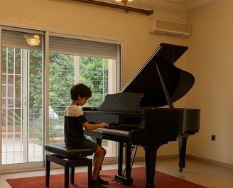a young boy playing a piano in a living room