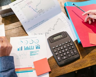 calculator and charts representing business and consulting