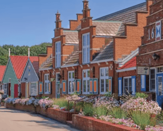 a row of houses with blue shutters and red brick walls