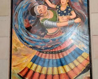 An artistic representation of two women engaged in a lively dance, set against a colorful wall.