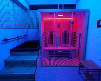 An infrared sauna and cold plunge with blue relaxing lighting