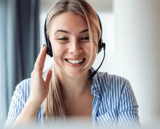 Friendly real estate photography customer support agent assisting a client via headset