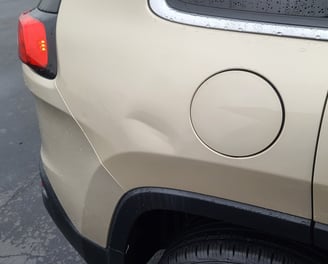 Large dent in Jeep Cherokee before pdr repair