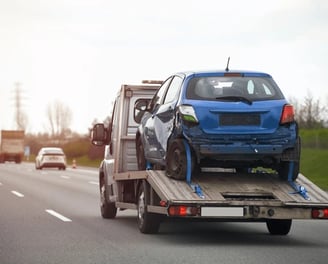 a tow truck with a flat bed and a car