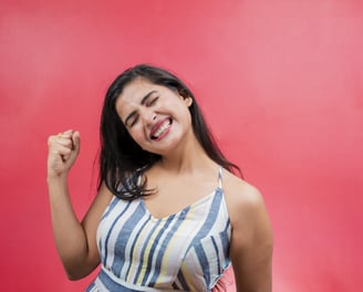 a woman with a smile on her face and a red background