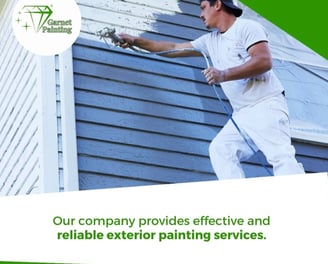 Garnet Painting team working on exterior house painting with company logo visible”