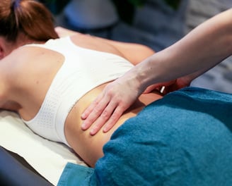 Sports Therapist providing a back massage to a client