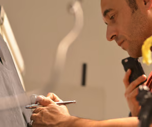 a man is writing on a blackboard