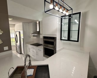 Kitchen remodel with wood accents, large prep island, and under-cabinet lighting by Central Florida