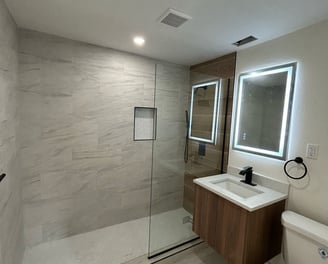 Bathroom renovation in Kissimmee with walk-in shower, ceramic tile, and modern vanity — remodel by F