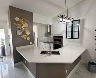 Luxury kitchen transformation with built-in oven, new countertops, and modern backsplash — remodelin