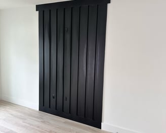 Interior door remodeling project featuring new white panel doors and black matte handles in resident