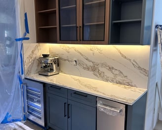 Open-concept kitchen renovation featuring island installation, pendant lighting, and custom cabinetr
