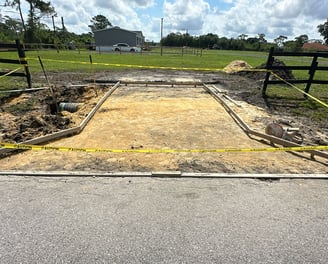 Concrete driveway construction in Kissimmee, FL with reinforced foundation and clean edge finishing