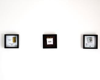 a white wall with frames for ambitious people