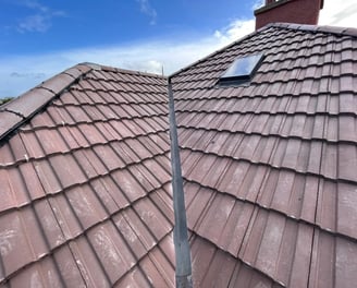 a newly installed affordable roof with a vellum window