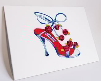 a greeting card with a red shoe with a shoelaced shoe