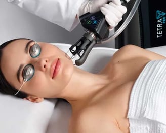 a woman getting a laser treatment from a laser machine