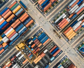 an aerial view of a large number of containers stacked in a port terminal