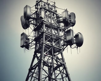 A wall with electrical and telecommunications equipment, including several distribution boxes and a network of intricately arranged cables. A small bird is perched near the top section of the wires.