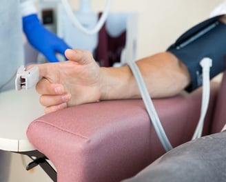 a person with a blood pressure monitor on their arm
