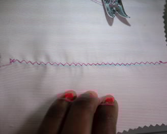 Zig zag stitches shown on pink fabric