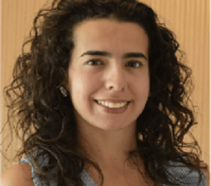 a woman with curly hair and a blue dress
