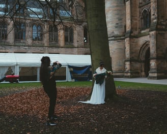 a bride standing in front of a large building