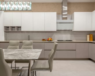 a kitchen with a marble table and chairs