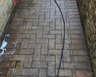 a hose is attached to a brick wall