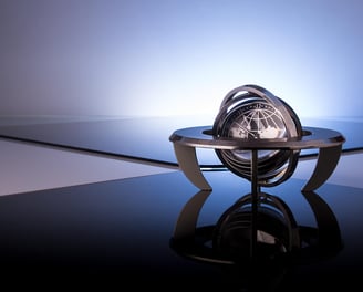 An industrial-style globe with a metallic finish, symbolizing global reach and precision.