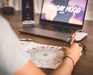 Mandala page book is colouring by a person