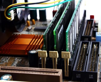 A close picture of a motherboard with 3 sticks of RAM installed