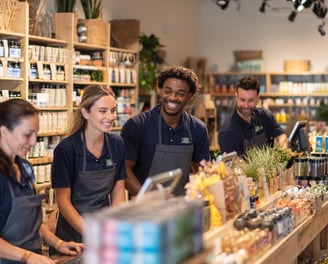 a group of people standing around a counter in a health shop