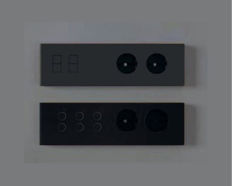 Diseño minimalista con interruptores empotrados en pared blanca junto a escalera contemporánea