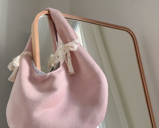 a pink purse with a bow tie on it