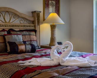 a swan towel on a bed