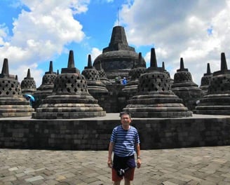 Majestic Borobudur Temple with its intricate stone carvings and bell-shaped stupas.
