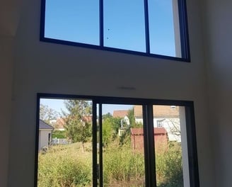 Nettoyage de vitres en hauteur, montrant un technicien en action avec un équipement spécialisé